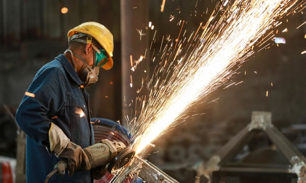 A worker polishes metal at a factory in Hangzhou, China.