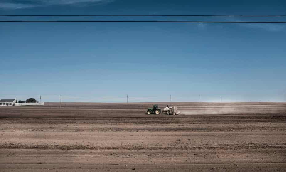 a tractor ploughs a field at a farm in Durbanville, South Africa