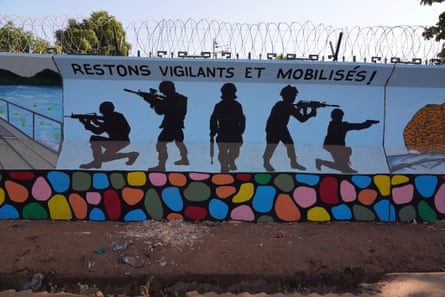 A mural of five silhouetted military figures in Ouagadougou, Burkina Faso