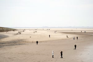 People stroll along the beach in Blackpool, Lancashire