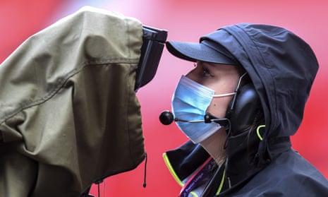 A TV camera operator wears a face mask during the match between Manchester United and Bournemouth.
