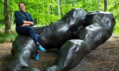 Tracey Emin poses on her sculpture I Lay Here for You.