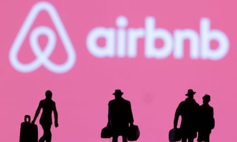 Figurines in front of Airbnb logo