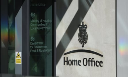 Polished metal sign by the door of the Home Office