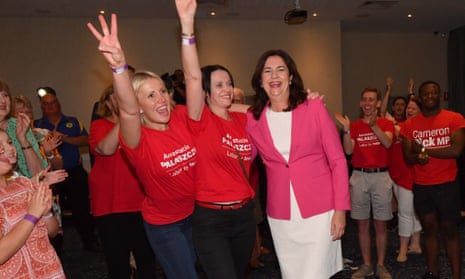Queensland premier Annastacia Palaszczuk celebrates victory with her sisters Julia, left, and Nadia, centre, at the Blue Fin Fishing Club
