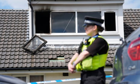 A police officer at the scene of the fatal house fire