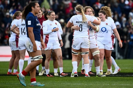 England's players react after winning the Women's Six Nations Grand Slam.