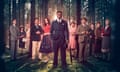 The cast of Murder is Easy standing ensemble in the midst of a forest, David Jonsson's Luke in the foreground, holding an umbrella. Other cast members are Dr Thomas (Mathew Baynton), Mrs Humbleby (Nimra Bucha), Rev Humbleby (Mark Bonnar), Lord Whitfield (Tom Riley), Bridget (Morfydd Clark), Miss Pinkerton (Penelope Wilton), Major Horton (Douglas Henshall), Rivers (Jon Pointing), Honoria Wayneflete (Sinéad Matthews) and Mrs Pierce (Tamzin Outhwaite).