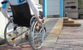 Woman in a wheelchair using a ramp.