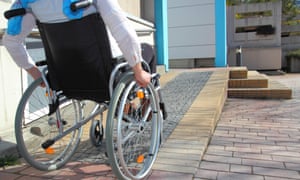 A wheelchair-user using a ramp