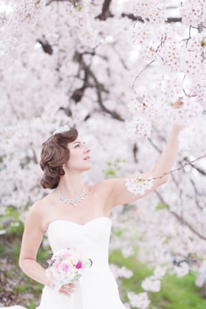 Naomi Harris poses for a wedding picture in a Japanese garden with cherry blossom
