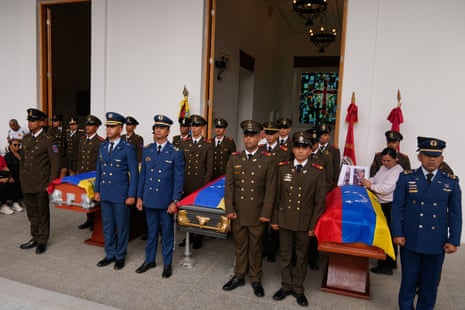 Military personnel standing by the coffins of slain soldiers