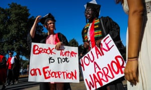 Stanford students Miriam Natvig (L) and Jemima Oslo (R) carried signs in solidarity for a Stanford rape victim during graduation ceremonies at Stanford University, in Palo Alto, California, on June 12, 2016.  
Stanford students are protesting the universitys handling of rape cases alledging that the campus keeps secret the names of students found to be responsible for sexual assault and misconduct. / AFP PHOTO / GABRIELLE LURIEGABRIELLE LURIE/AFP/Getty Images