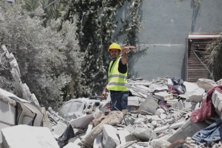 A rescue worker in the rubble of the Khatib home.