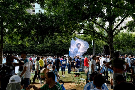 Argentine fans participate in a flag-waving event at Klyde Warren Park in Dallas.