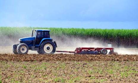 A tractor ploughs a sugarcane field in north Queensland