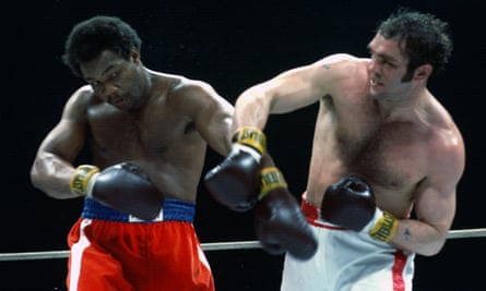 George Foreman (left) fights Boone Kirkman in the fifth of five three-round bouts on April 26, 1975 at the Maple Leaf Gardens in Toronto, Ontario