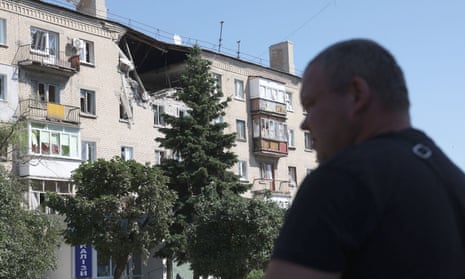 A man walks in front of damaged residential building on a street of the town of Lysychansk on June 21, 2022, amid the Russian invasion of Ukraine.