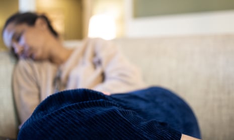 a woman napping on a sofa in out of focus shot