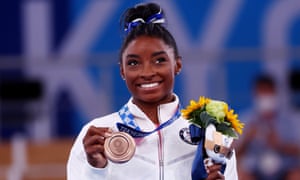 Bronze medallist Simone Biles of the United States celebrates on the podium.