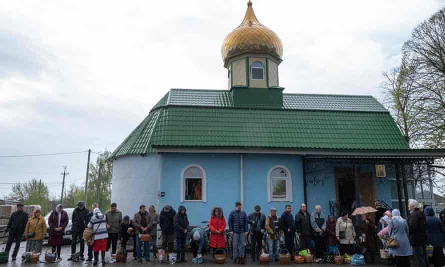 Worshippers wait to receive sanctification during an Orthodox Easter service in Lyman, Ukraine