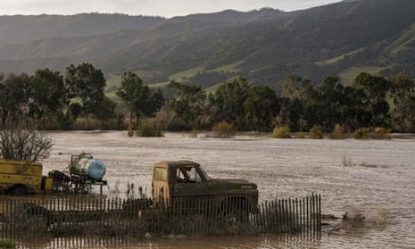 A truck is submerged in floodwaters from the Salinas River near Chualar, California on 12 January 2023.