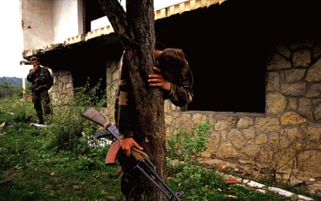 Senad Medanovic, sole survivor of a massacre finds his home in ruins after the Bosnian army recaptured his village from Serb forces. He is standing on what is believed to be a mass grave of sixty-­‐nine people, including his family. 1995