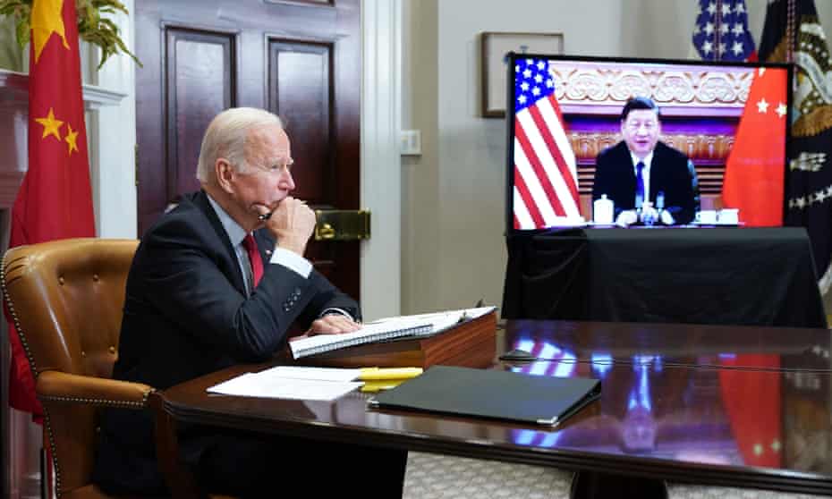 Joe Biden in the the Roosevelt Room of the White House talks to Xi Jinping during a virtual summit.