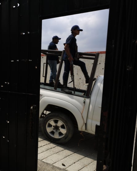 FUPCEG vigilantes drive past the bullet hole-riddled gate to a home where heavy fighting took place, in Filo de Caballos.