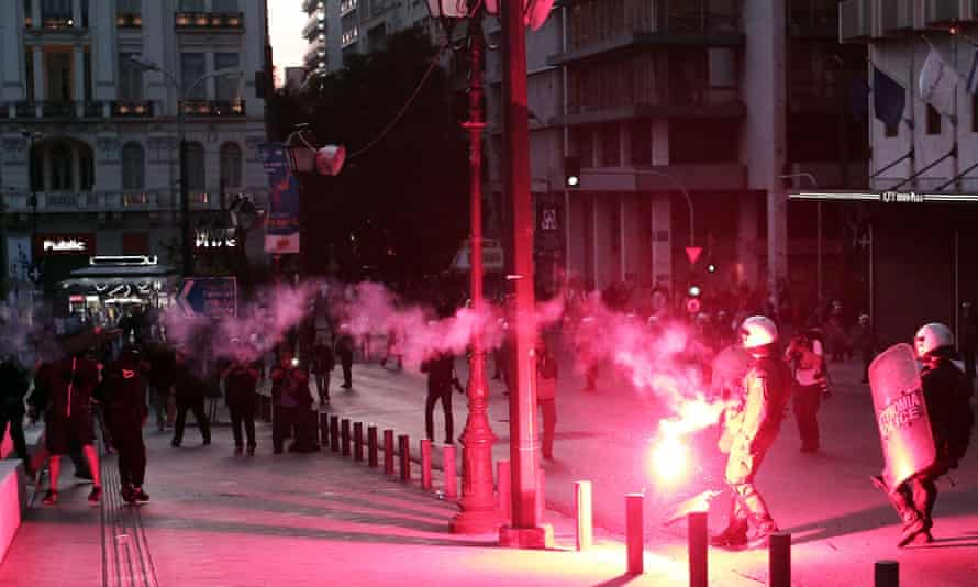 Protesters throw flares at riot police