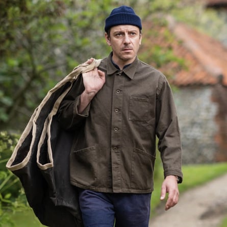 A man wears a work jacket made by Norfolk’s Carrier Company