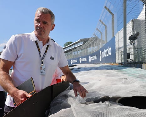 Niels Wittich inspects a track barrier.