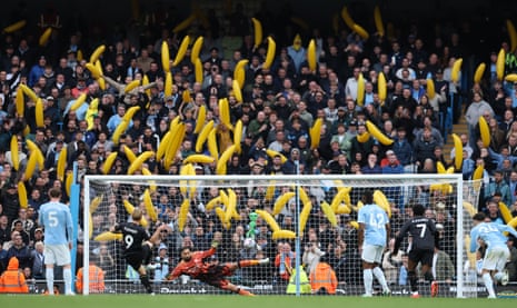 Zian Flemming scores a penalty past Donnarumma as Manchester City fans wave inflatable bananas