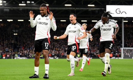Alex Iwobi waits to celebrate with his teammates after putting Fulham in front against Wolves.