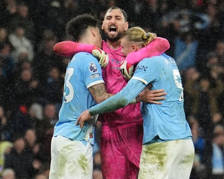 Manchester City goalkeeper Gianluigi Donnarumma celebrates with Nico O’Reilly and Erling Haaland after the final whistle of their victory over Newcastle.