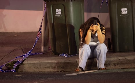 A young woman sits in the gutter, not long after the shootings at Bondi Beach, Sydney, Australia. 14 December 2025.