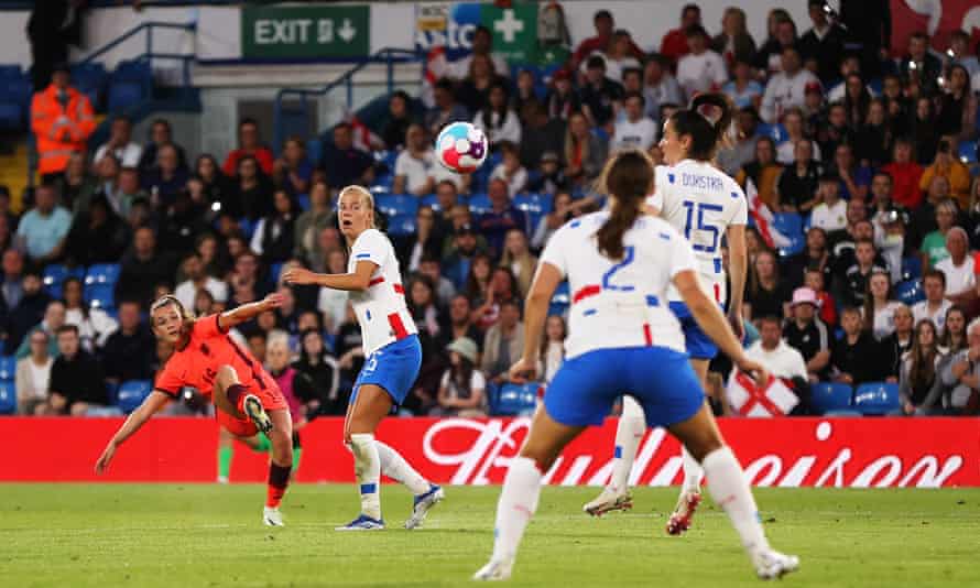 Ella Toone of England scores her team's third goal under pressure from Lynn Wilms of the Netherlands.