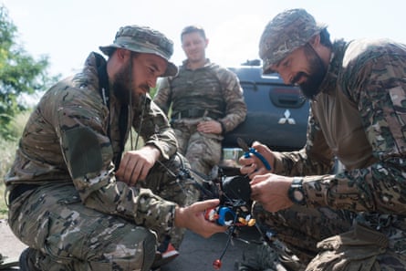 Left to right: Oleksandr, Olexsandr Majeur and Petro get ready to set up an FPV drone.