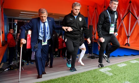 Óscar Tabárez, in his second spell as Uruguay manager, is helped to the pitchside for his team’s opening World Cup game against Egypt.