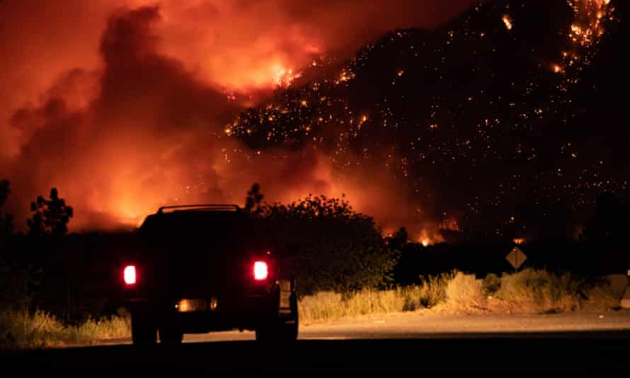 A wildfire burns on the side of a mountain in Lytton.