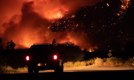 A motorist watches wildfires in Lytton, British Columbia