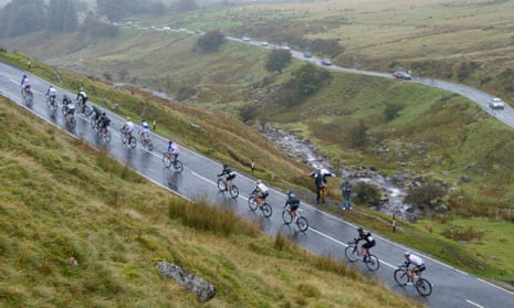 Tour of Britain riders ascend through driving rain in the Black Mountains of the Brecon Beacons.