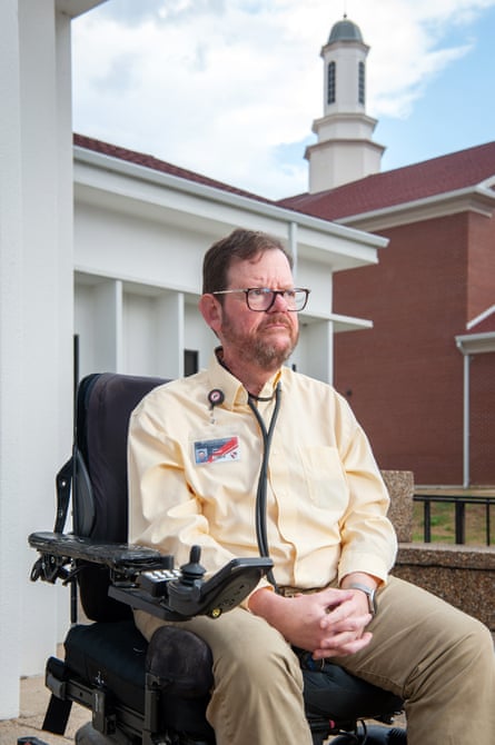 a man sitting in a chair outside