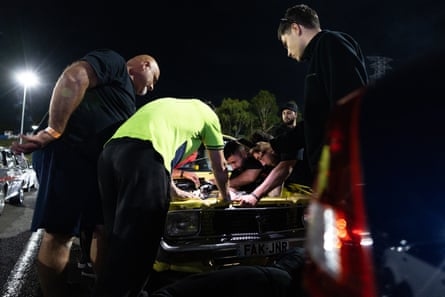 The team from Sik100 racing make quick adjustments after the engine shifted in the engine bay.