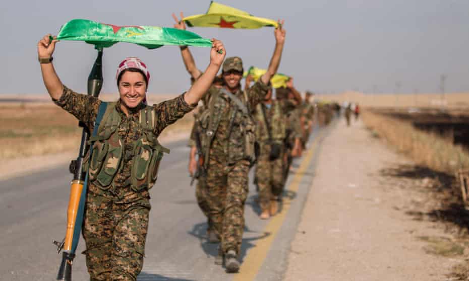 Kurdish fighters in northern Syria fly the flag. 