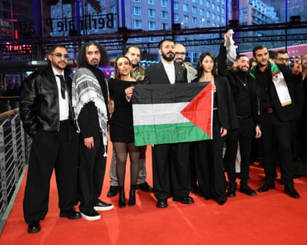 A group of people holding a flag