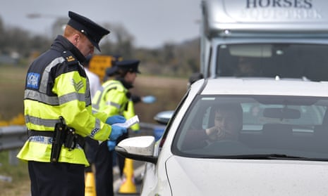 Police officers check for people engaging in non-essential travel outside the border town of Newry