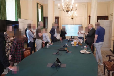 Boris Johnson (right) at a gathering celebrating his birthday - in which cake and alcohol was provided - in the cabinet room at 10 Downing Street,