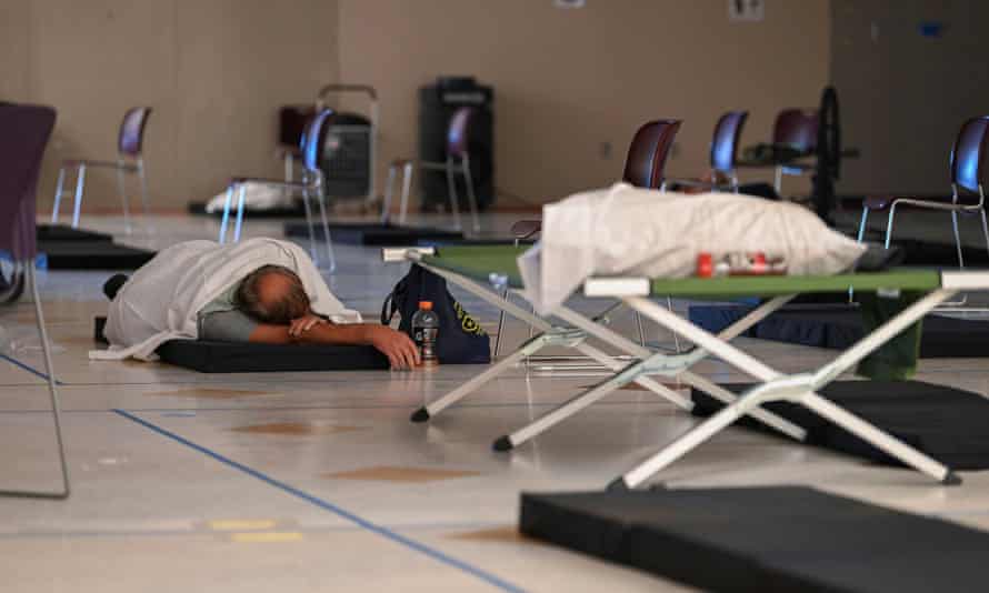 Extreme heat returns to Pacific NorthwestA man rests on a cot inside a cooling shelter during a heatwave in Portland, Oregon, U.S., August 11, 2021. REUTERS/Mathieu Lewis-Rolland