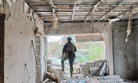 A DPR member is seen at Pisky village after shellings in Donetsk, Ukraine on 12 August.